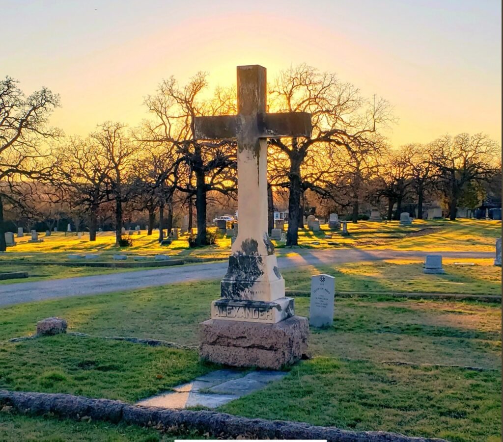 Sunset view of historic Oakwood Cemetery and monument